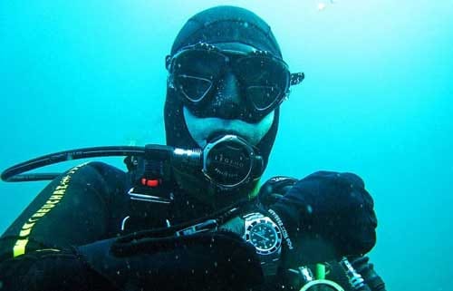 scuba diver wearing rolex watch