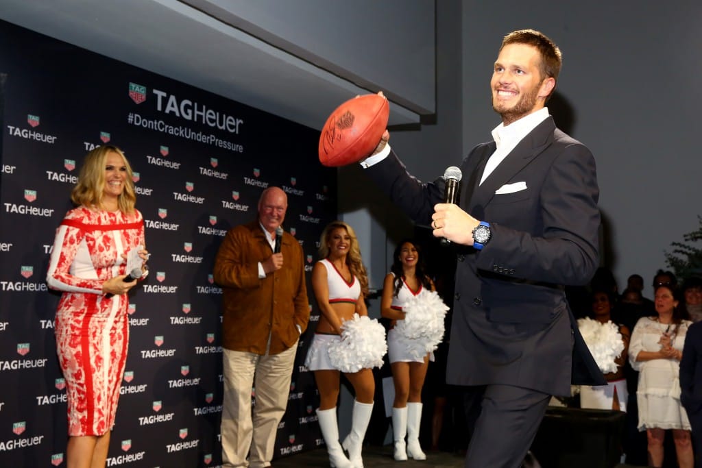 Tom Brady throwing signed footballs to raise money for the Best Buddies charity.