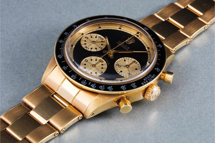 Rolex Cosmograph Daytona that is black and gold. Rolex Cosmograph Daytona