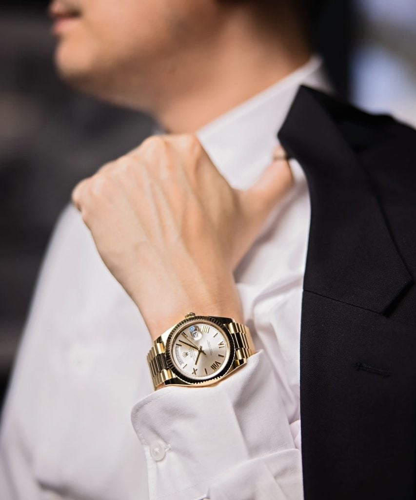 Rolex on wrist with black tie Rolex on wrist with black tie